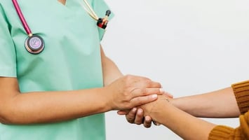 Clinician helping a person with IDD.