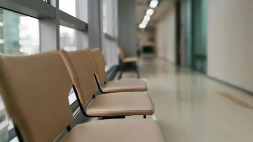 A clinic with empty waiting chairs. 
